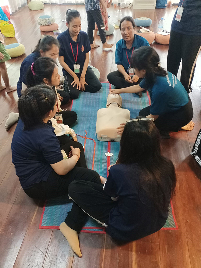 Hile Teuk Kampuchea (HTK) trainers teach a CPR class, using a dedicated CPR mannequin to ensure the trainees will be ready to help save a life if the need arises. HTK
