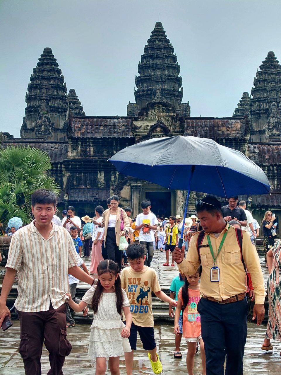 A guide escorts a family of Khmer tourists across the causeway at the Kingdom’s iconic Angkor Wat Temple. Siem Reap provincial tourism department