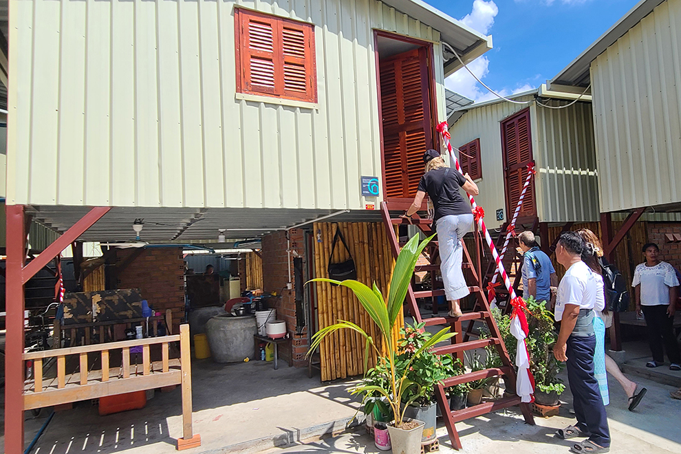 One of the donors visits one of the new homes in Lenkov village. Hong Raksmey