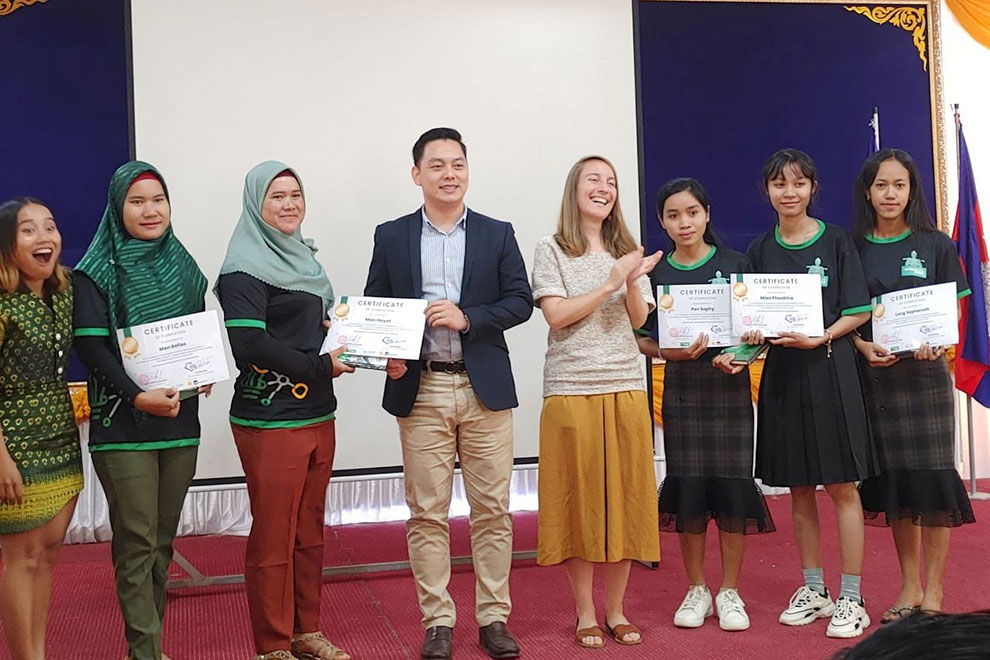 Man Hayyot (third from left) receives a certificate of completion after completing a Save the Children Cambodia course. Hyfp FB