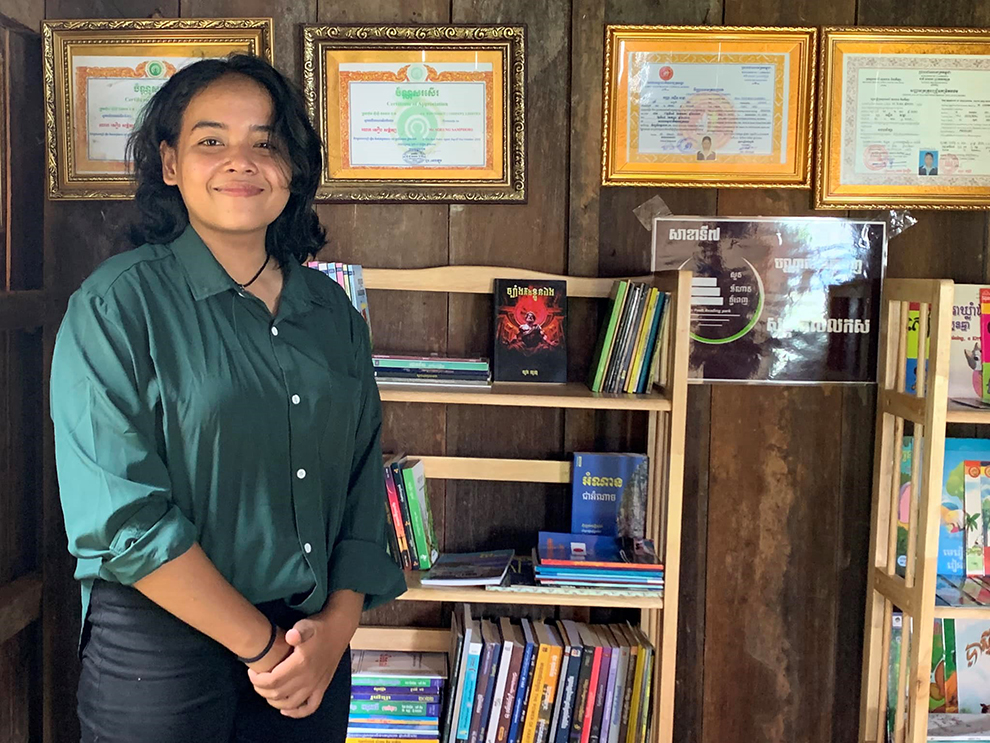 A proud Chhem Sreykea poses for a photograph at the 7th branch of her mobile library network. Chhem Sreykea