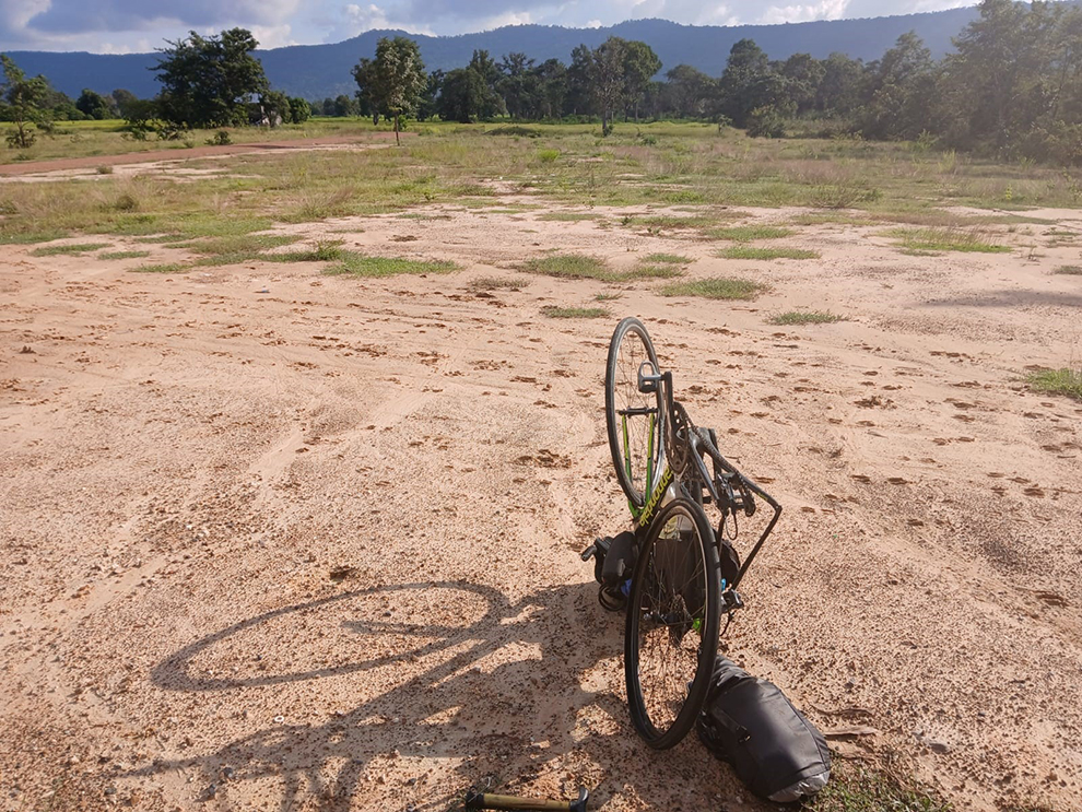 Tim makes a pit stop to fix a flat tyre on Route 62 after departing Krong Preah Vihear district in Preah Vihear province. Tim Jones