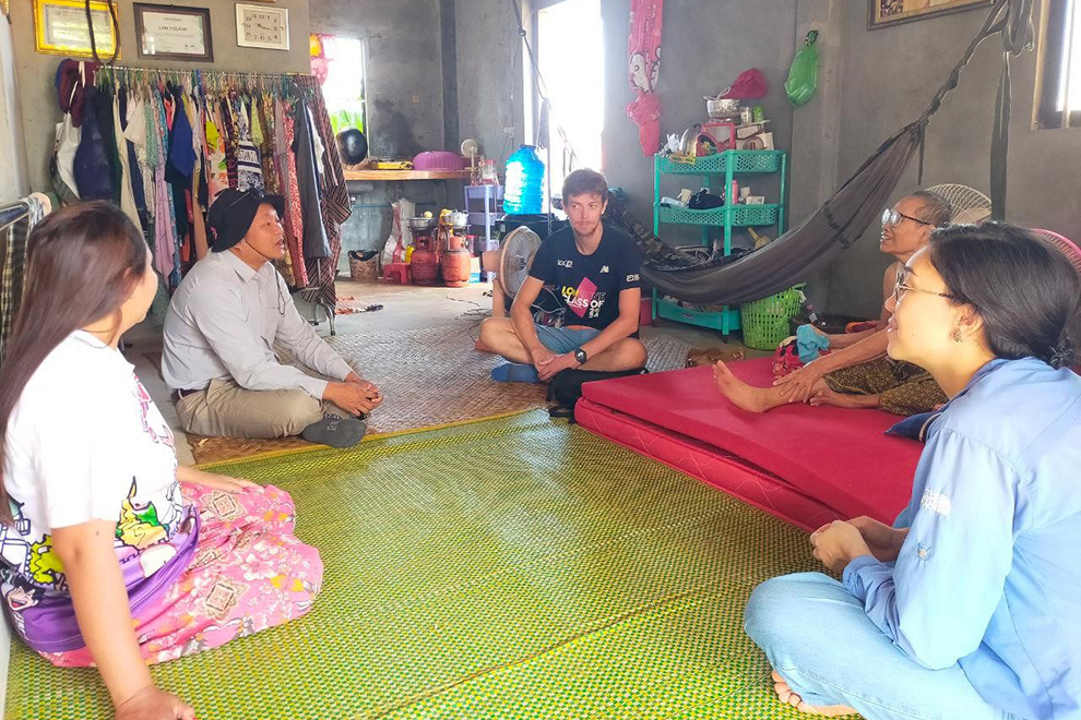 Tim meets with a blind woman and her family at the new housing complex in Siem Reap town’s Veal village on October 23. Supplied