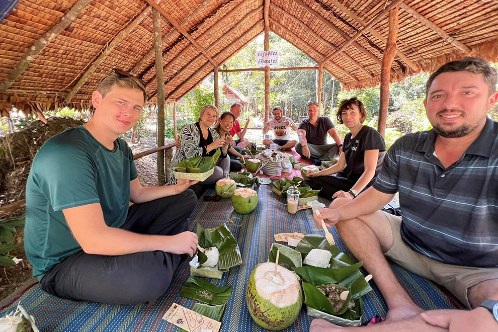 Tourists enjoy local food, prepared and served by the community. Supplied