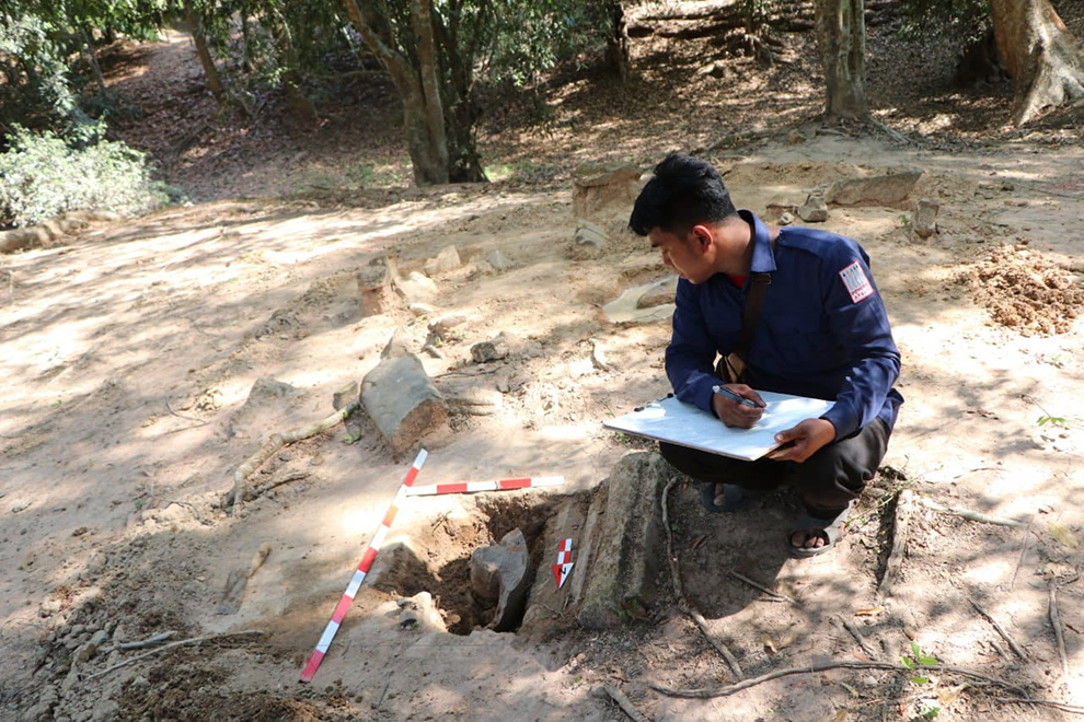 One of the APASARA National Authority (ANA) team notes the precise measurements and features of one of the newly discovered national treasures. ANA