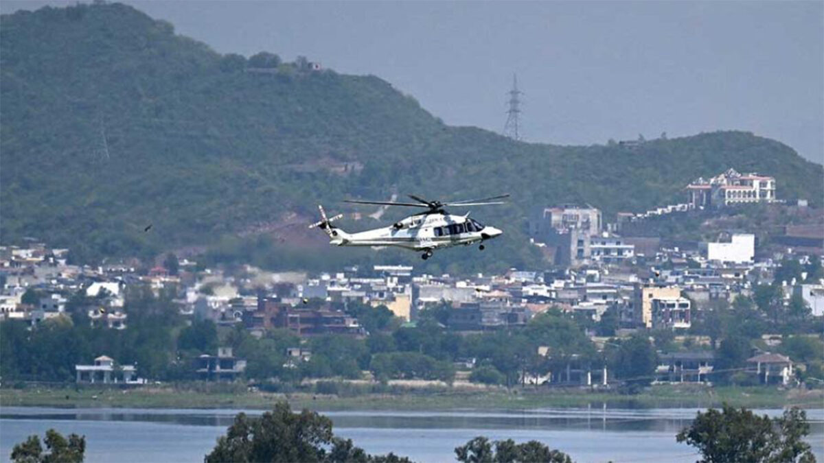 A helicopter flies over the Red Zone area in Islamabad on April 20, 2026, amid heightened security measures ahead of anticipated US-Iran peace talks. PHOTO: AFP