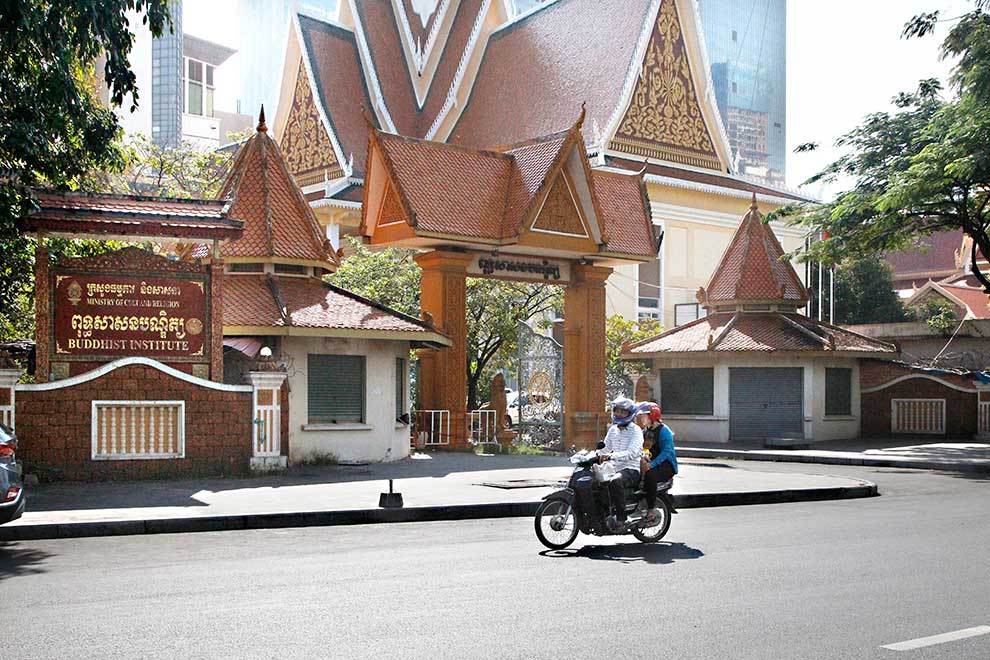 A couple and their child ride past the Buddhist Institute in Tonle Bassac commune of Phnom Penh’s Chamkarmorn district.