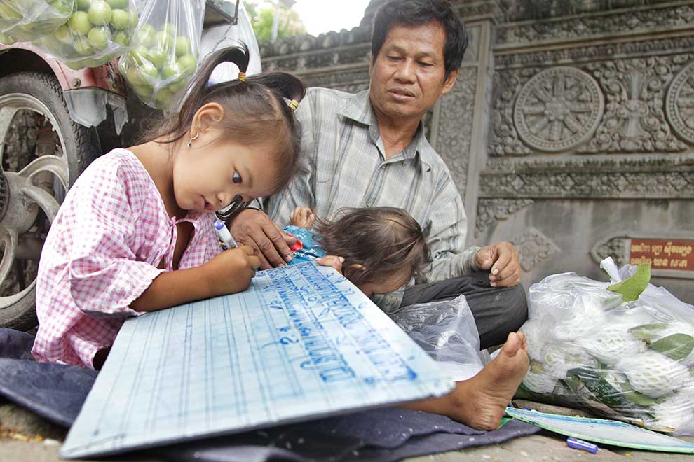 Sidewalk guava seller tutors children