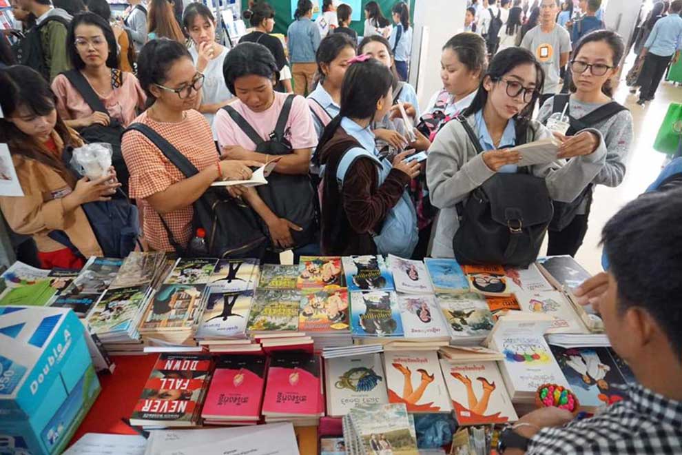 Students look at books on sale at the Khmer Literature Festival in 2019 in Battambang. SUPPLIED