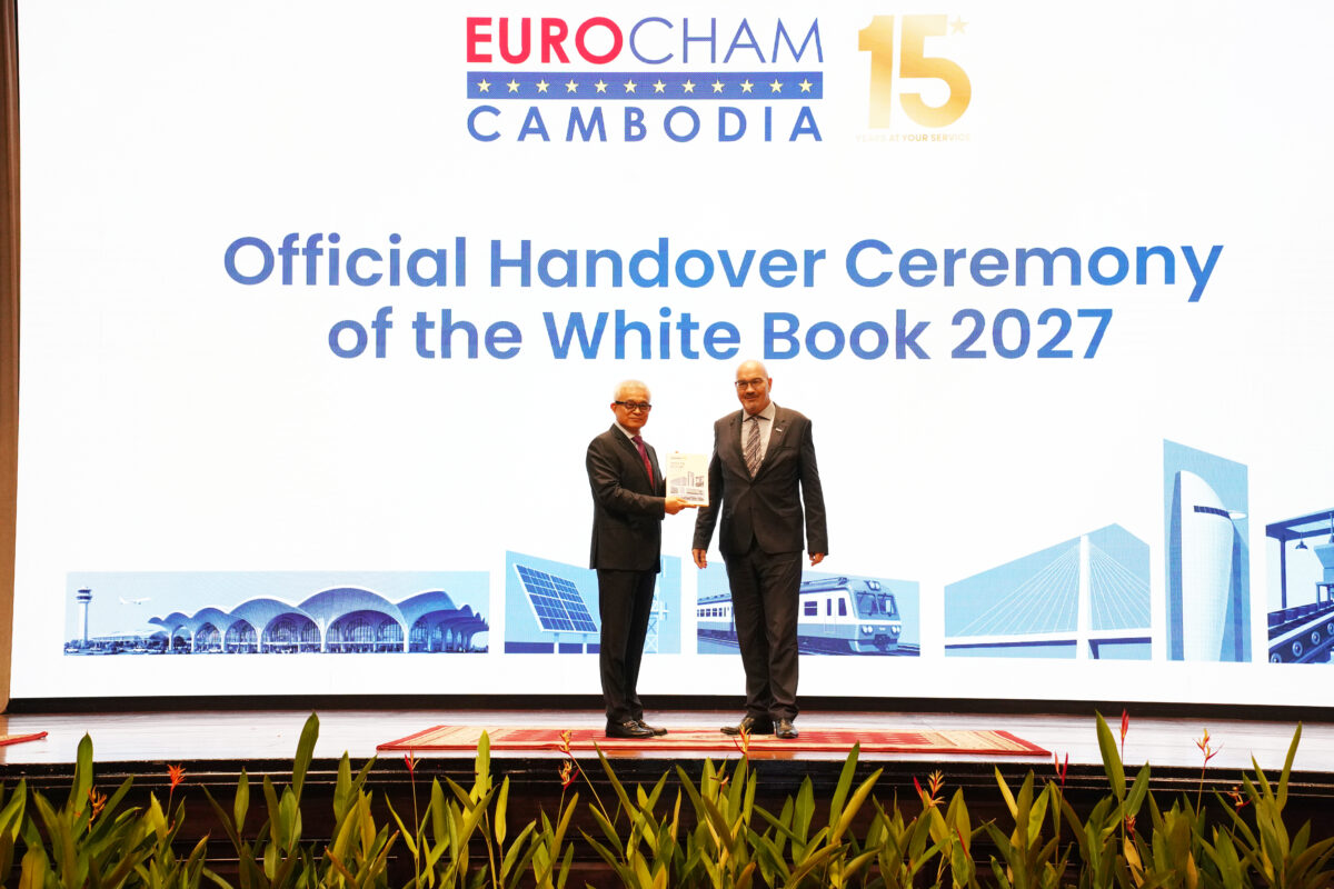 Minister of Economic and Finance Aun Pornmoniroth receives the EuroCham Cambodia White Book 2027 from EuroCham Cambodia chairman Tassilo Brinzer. Hong Raksmey